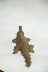 Textured back and spiked tail of a vintage African bronze crocodile sculpture.