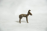 Side profile of the vintage bronze ram gold weight, showing its handmade form and dark patina.