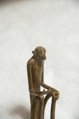 Vintage African bronze monkey sculpture, aged patina, with an expressive face and gesturing hand.
