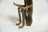 Vintage African bronze monkey sculpture showing bent legs, feet, and hand at knee.