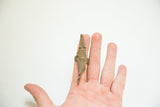 A hand models the statement vintage bronze crocodile ring, showing its long profile.