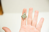Palm-side view of the vintage bronze alligator ring demonstrating its size on a hand.