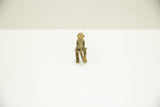 Rear view of the vintage bronze monkey showing its textured spine and curved tail.