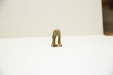 A straight-on view of the small, collectible African bronze monkey.