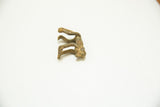 Side view of the vintage bronze monkey showing its elongated limbs and rustic texture.