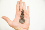 Vintage African bronze Ashanti spoon with a figural handle held in hand for scale.