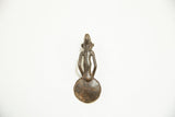 The back of the cast bronze figure on a vintage African Ashanti spoon.