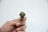 Top-down view of the vintage bronze pelican ring, showing its aged sculptural form.