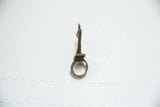 Side profile of a vintage cast bronze pelican ring showing its tall form and rustic finish.