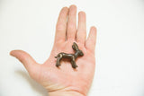 Vintage African bronze rabbit gold weight with patina in an open hand.