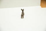 Back view of the vintage African bronze rabbit, detailing its tail and rustic casting.