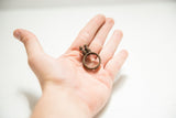 Vintage African bronze double bird ring resting in a palm for size reference.