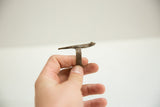 Side view of the vintage bronze gecko ring, showing its elongated shape and textured band.