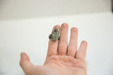 Vintage African bronze gecko ring worn on a finger to show its scale and fit.