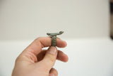 Side view of a vintage bronze gecko ring highlighting its woven band texture.