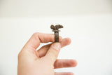 Side profile of the vintage African bronze chameleon ring showing its scale and textured band.