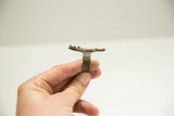 Profile view of a vintage African bronze ring showing the thick band and casting.