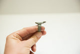 Profile view of a cast bronze lizard ring showing its textured band and patina.