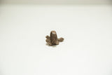 Rear profile of a vintage bronze turtle ring showing the rustic, textured band.