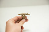 Detailed casting of a crocodile on a vintage brass ring with a cross-hatch band.