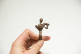 Vintage bronze warrior ring held to show the sculpted profile and scale.