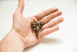 Vintage African bronze panther ring with an aged patina held in hand for scale.