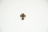 A vintage African copper ring with two abstract figures and a textured band.