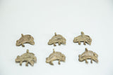 Multiple vintage bronze double chameleon pendants showing variations in their aged patina.