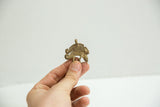 Detail of the vintage bronze chameleon pendant showing its scale and matte patina.