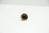 View into the hollow opening of a textured vintage African bronze bell.