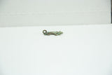 Side profile of a cast bronze lizard charm showing its aged, greenish patina.