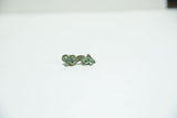 Vintage African bronze chameleon charm showing its aged texture and mottled green patina.