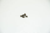 A vintage cast bronze frog charm showing its profile and oxidized texture.