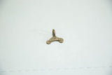 Hand-cast surface and time-softened patina on a vintage African bronze charm.