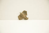 Side view of the vintage bronze elephant charm highlighting its aged patina.