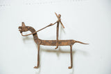 Vintage African iron horseback warrior sculpture with rustic texture and deep patina.