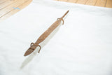 High-angle view of the vintage African bronze lizard, showing its full length and rustic patina.