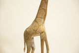 Detailed view of the etched patterns and vintage patina on the bronze giraffe sculpture.