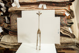 Vintage African bronze giraffe sculpture standing, showing its full tall and slender form.