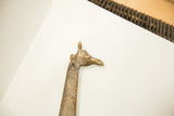 The expressive sculpted head and patterned neck of a vintage African bronze giraffe.