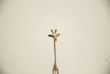 Detailed view of the vintage bronze giraffe's cast head and slender neck.