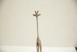 The face and long, patterned neck of a vintage African bronze giraffe sculpture.