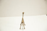 Rear view of a slender vintage African bronze camel with aged patina.