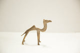 Vintage African bronze camel figurine showing its slender form and textured surface.