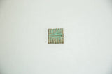 A single vintage bronze coin with ridged lines and a heavy green verdigris patina.