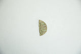 Vintage African decorative bronze coin with aged patina and linear pattern.