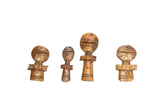 Four vintage carved wood person pendants showing natural variations in size and patina.