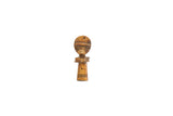 A vintage carved wood person pendant with incised details and a warm patina.