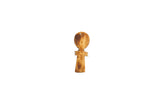 A vintage carved wood person pendant with a distinct rustic patina.