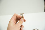 A single vintage African bronze ring showing its sculptural top and aged patina.